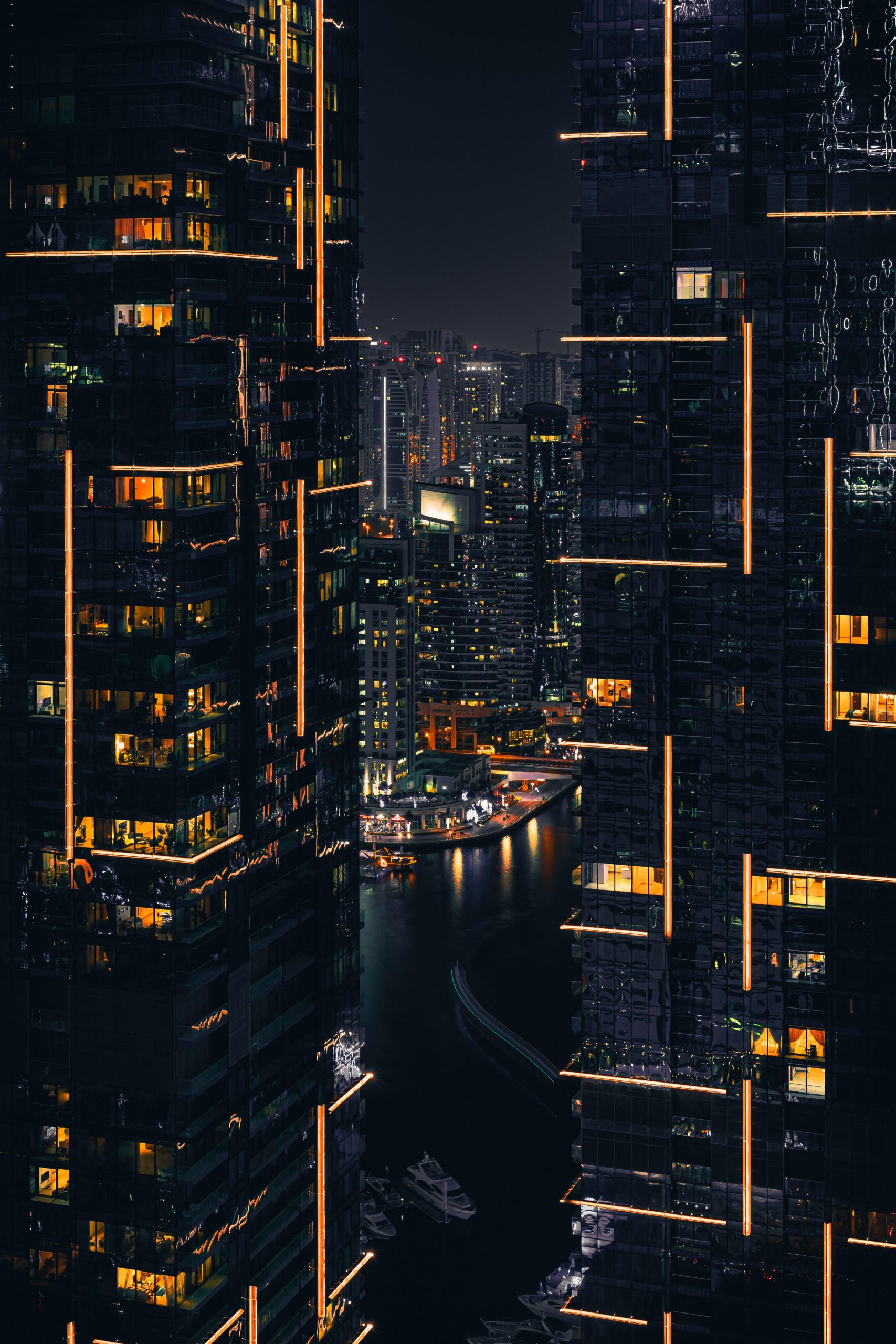 Portrait of tall urban buildings illuminated by yellow lighting